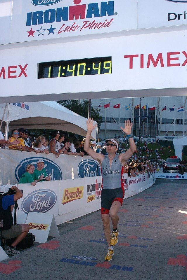 Arthur Dembro crossing the Ironman finish line